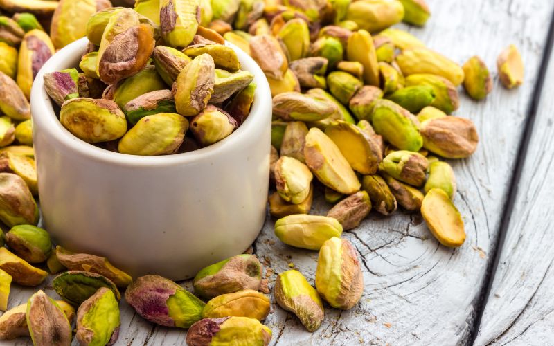 Shelled pistachios getting ready to be used in a beet salad for crunch and texture 