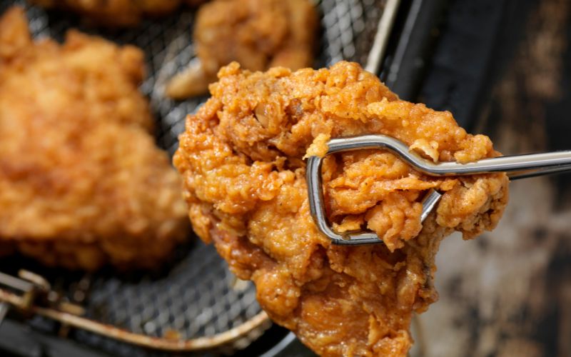 Crispy golden fried chicken just out of the fryer. 