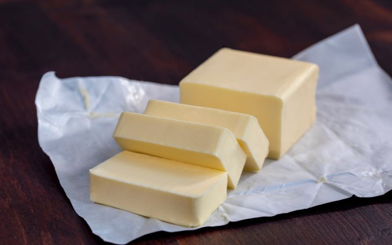 High -fat cultured butter being spread thick- the chef's secret to a perfect sandwich.