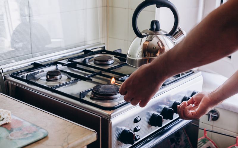 Match lighting a gas stove in a home 