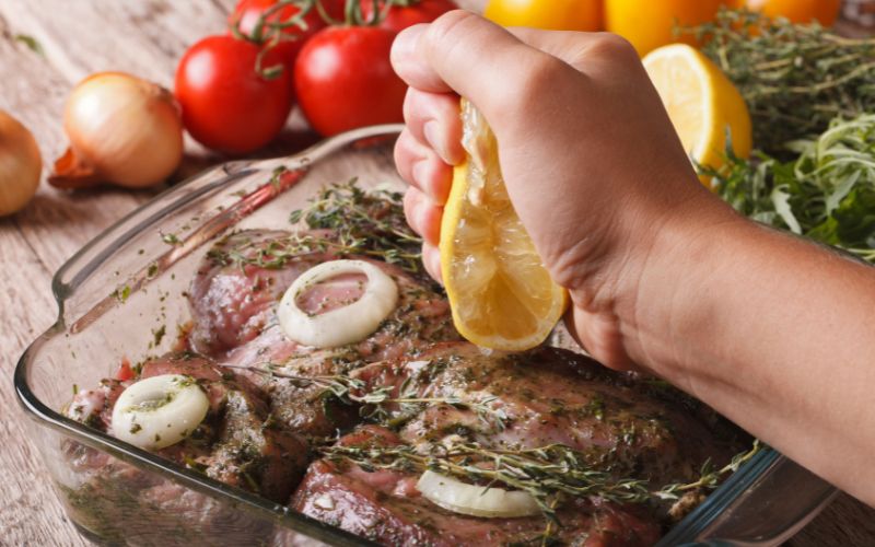Chef Alexis Hernandez finishing a dish with lemon to balance flavor