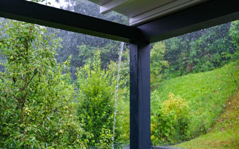 A rainy afternoon view from a porch.