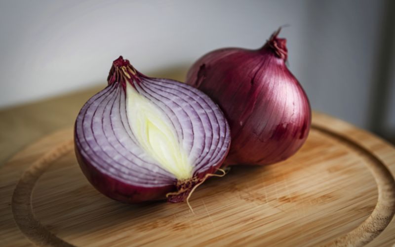 Red Onions sliced in half on a cutting board