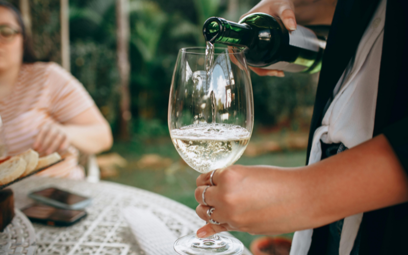 Pouring Wine as a good host at a party 