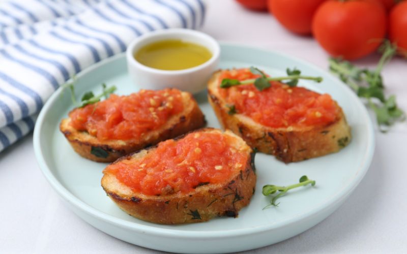 Summer cooking grated tomatoes on toasted bread