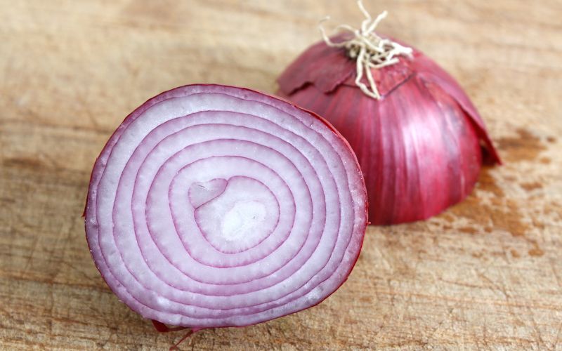 Sliced red onion getting ready for a fresh finish for soup